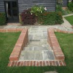 Paved steps down to patio area and patio doors to property