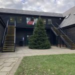 Real outdoor Christmas tree installed outside commercial office building