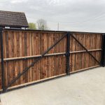 Close board wooden double gates on metal frame to enclose rear garden entrance